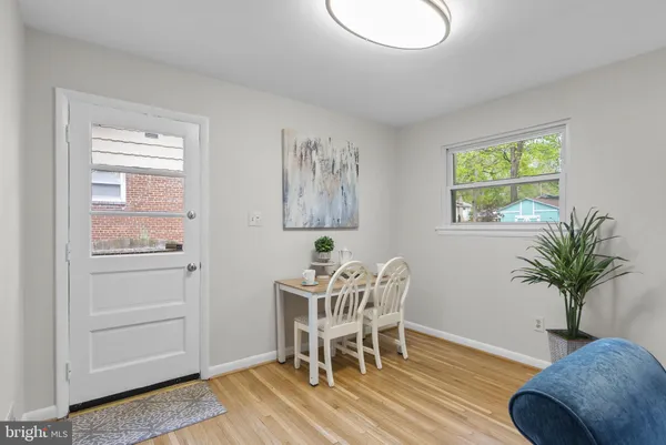 a view of a dining room with furniture window and wooden floor