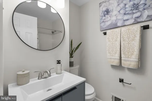a bathroom with a sink mirror and toilet
