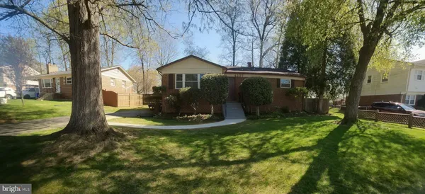 a front view of a house with a yard table and chairs
