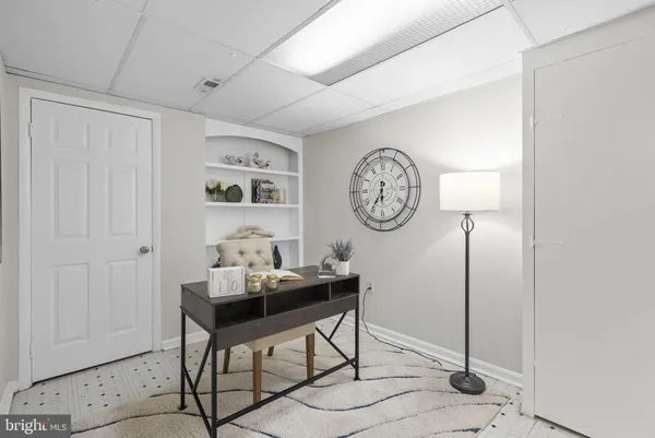 a view of a room with a table and a clock