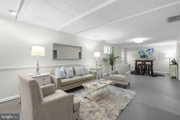 a living room with furniture and a lamp