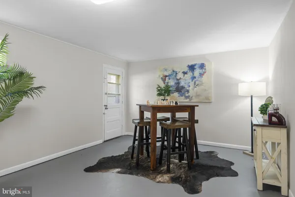 a dining room with furniture and entryway
