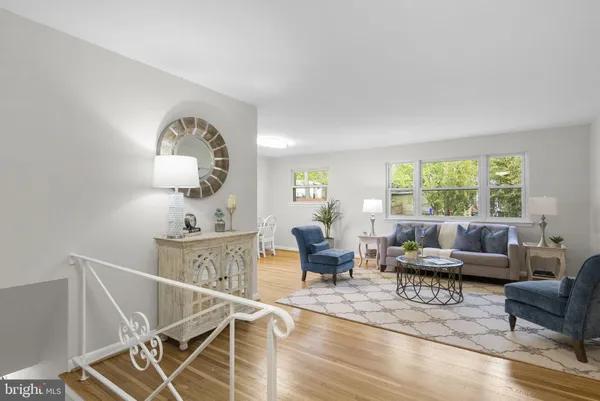 a living room with furniture a rug and a large window