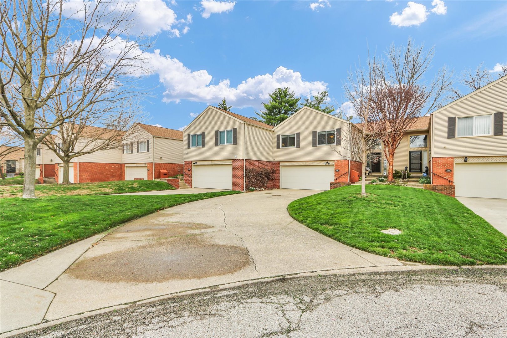 29 Fields East Champaign, IL 61822 - Photo 3 of 46 a front view of a house with a garden and trees
