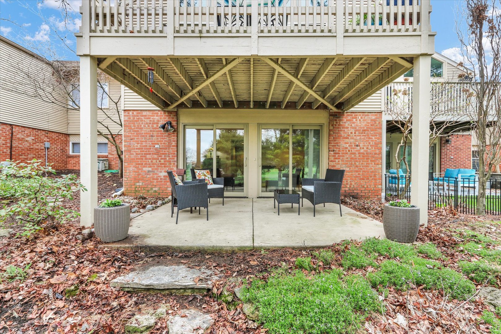 29 Fields East Champaign, IL 61822 - Photo 40 of 46 a view of a patio with table and chairs potted plants and floor to ceiling window and wooden floor