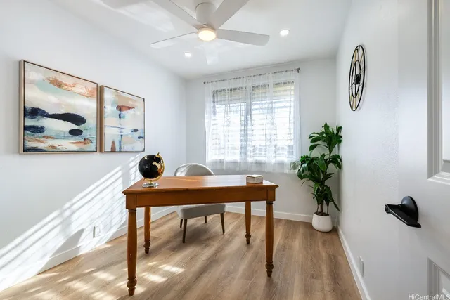 a view of a workspace with furniture and a potted plant