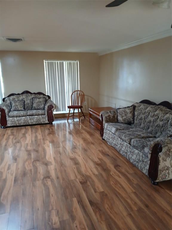 8809 Avondale Lane Hudson, FL 34667 - Photo 13 of 20 a living room with furniture and a wooden floor