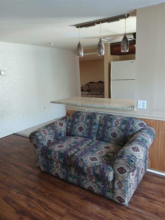 8809 Avondale Lane Hudson, FL 34667 - Photo 16 of 20 a living room with furniture and a wooden floor