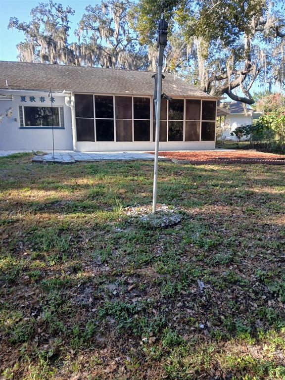 8809 Avondale Lane Hudson, FL 34667 - Photo 18 of 20 front view of a house with a yard