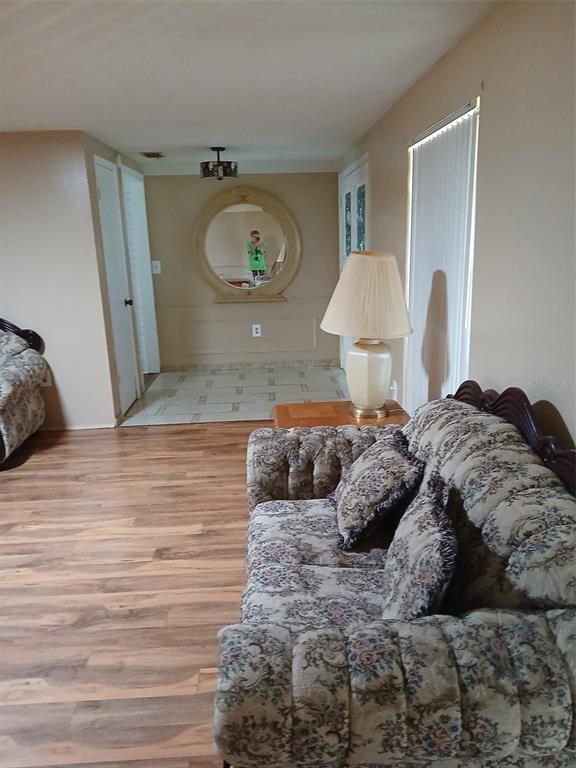 8809 Avondale Lane Hudson, FL 34667 - Photo 3 of 20 a bedroom with a bed and a chandelier