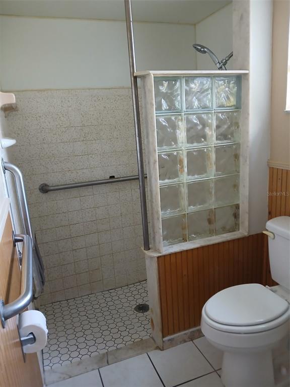 8809 Avondale Lane Hudson, FL 34667 - Photo 8 of 20 a bathroom with a toilet and a shower