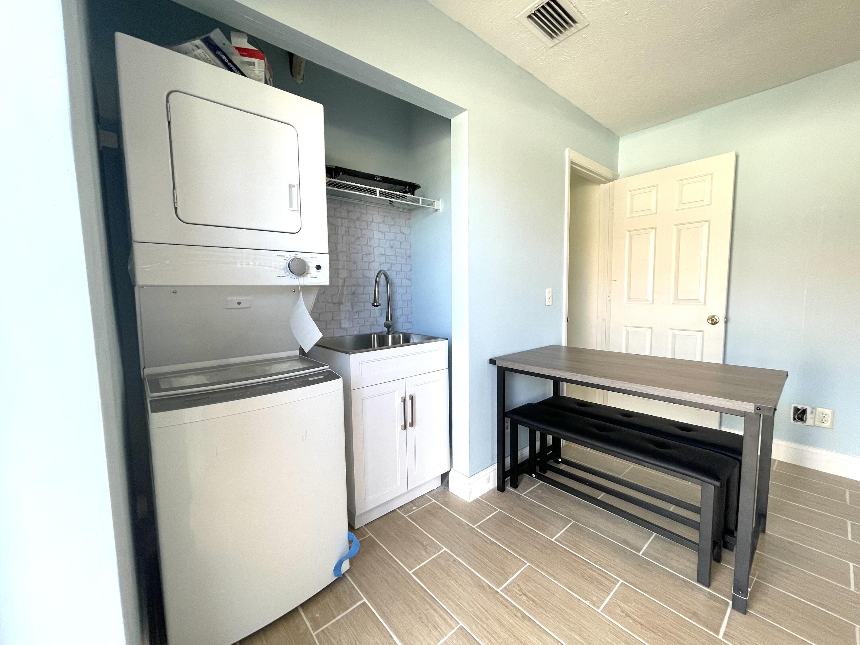 5753 Southeast Mercedes Avenue Stuart, FL 34997 - Photo 3 of 24 a utility room with dryer and washer