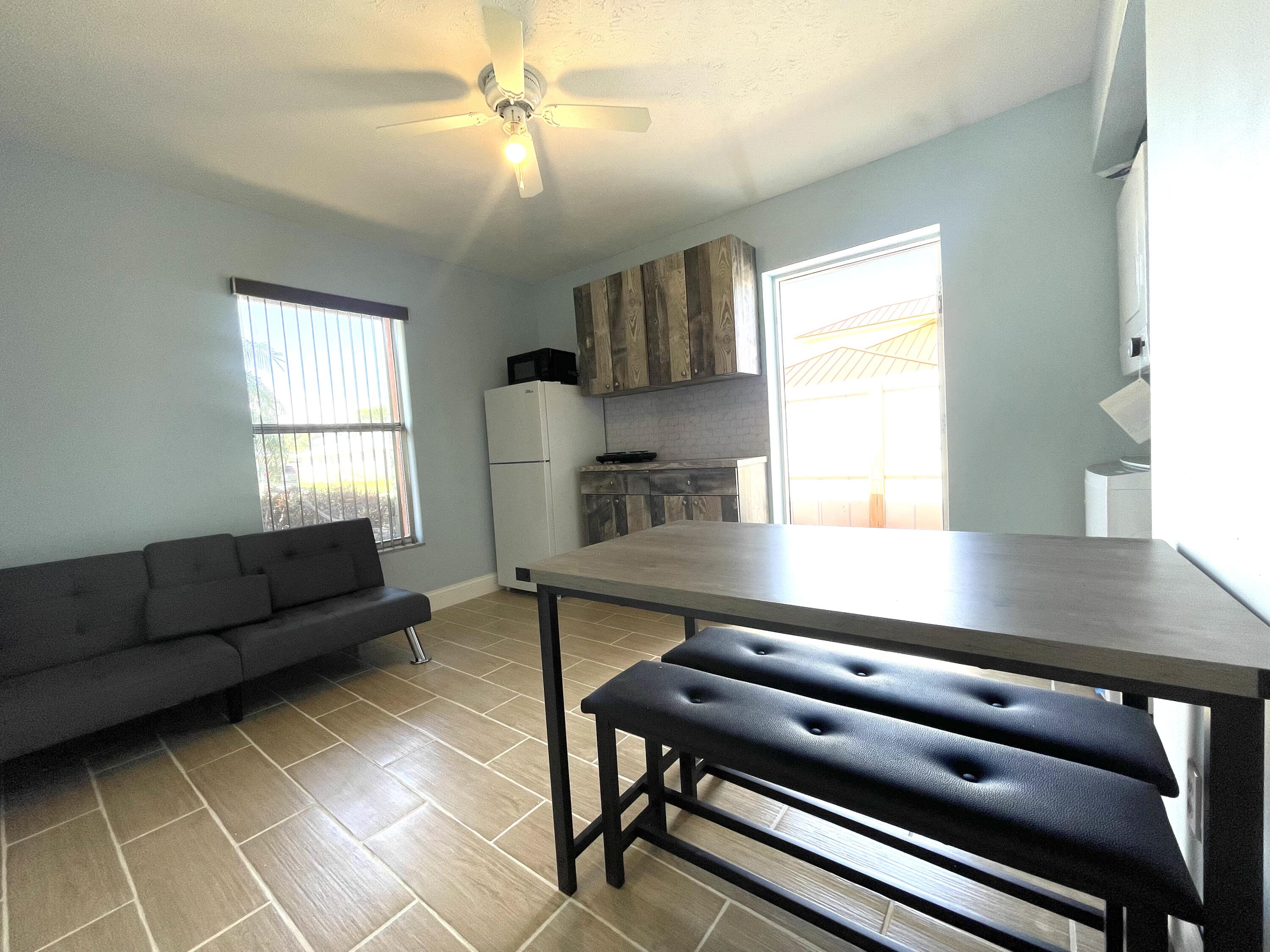 5753 Southeast Mercedes Avenue Stuart, FL 34997 - Photo 4 of 24 a living room with furniture and a window