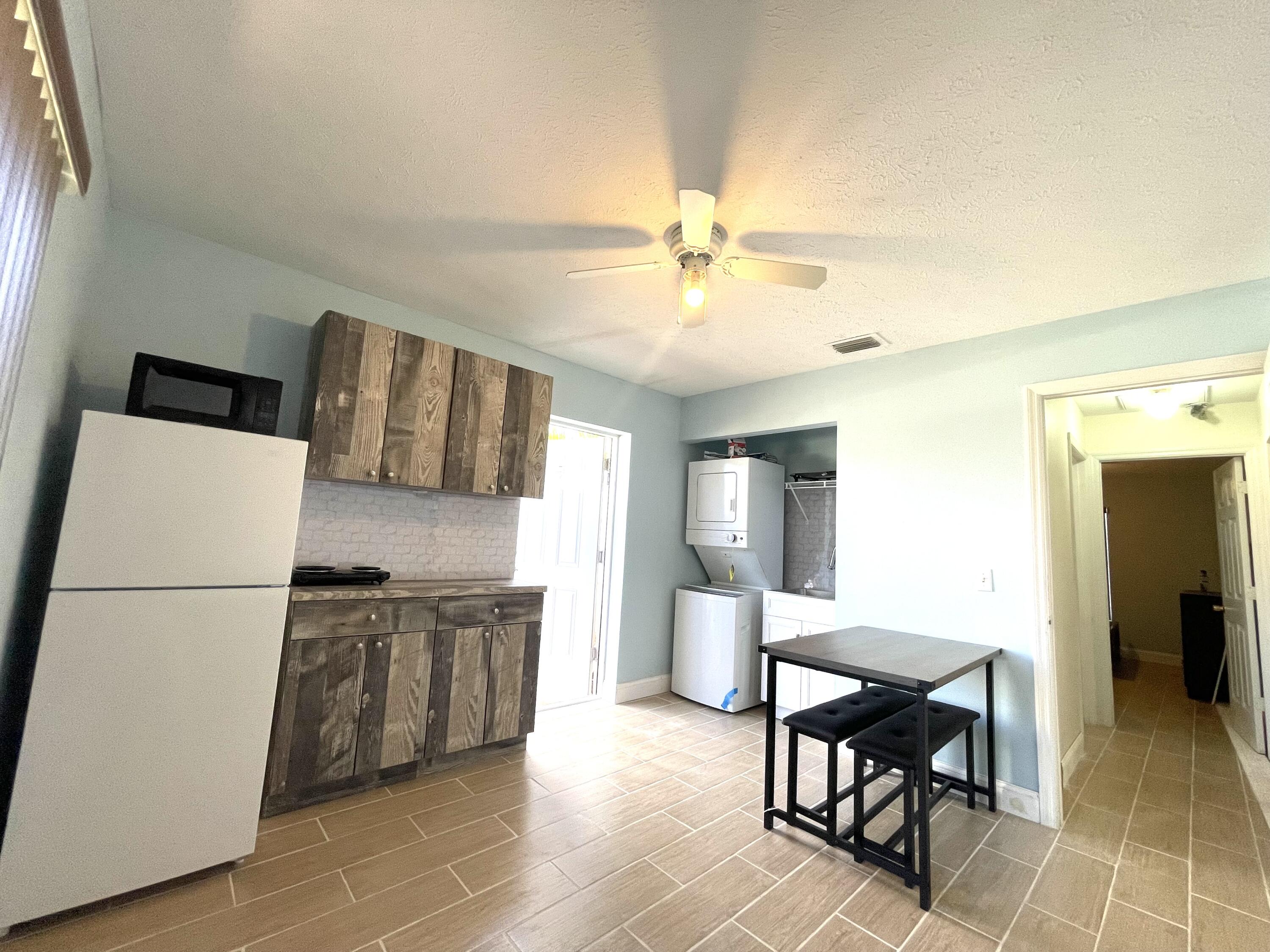 5753 Southeast Mercedes Avenue Stuart, FL 34997 - Photo 8 of 24 a view of kitchen with furniture and wooden floor
