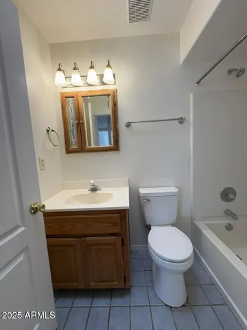 a bathroom with a toilet a sink and bathtub