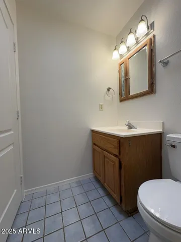 a bathroom with a sink a toilet and mirror