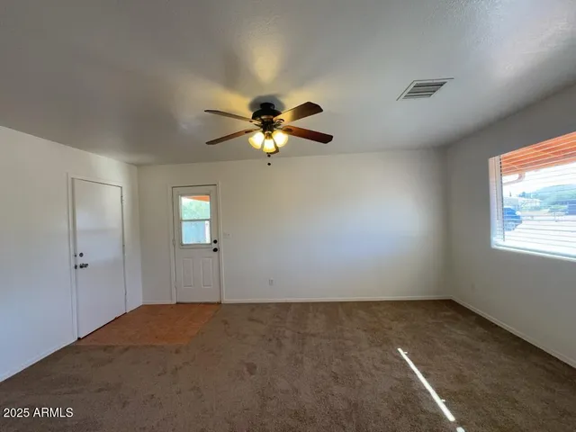 a view of a livingroom with a chandelier fan