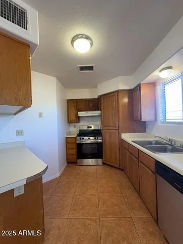 a kitchen with stainless steel appliances a refrigerator and a stove