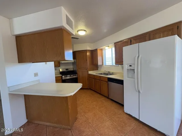 a kitchen with a refrigerator and a sink