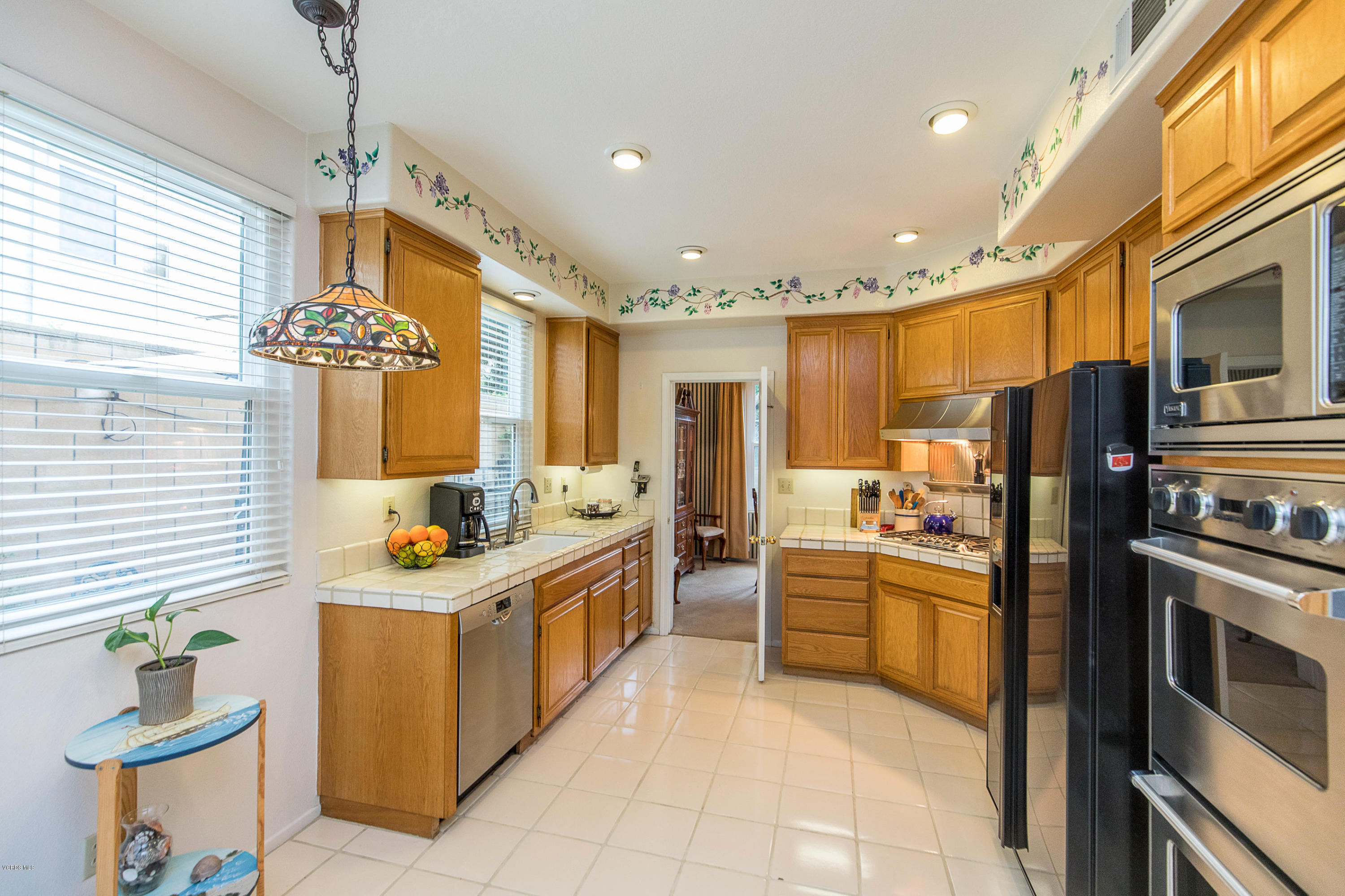 3959 Timberridge Road Moorpark, CA 93021 - Photo 16 of 48 a kitchen with stainless steel appliances granite countertop a stove and a refrigerator