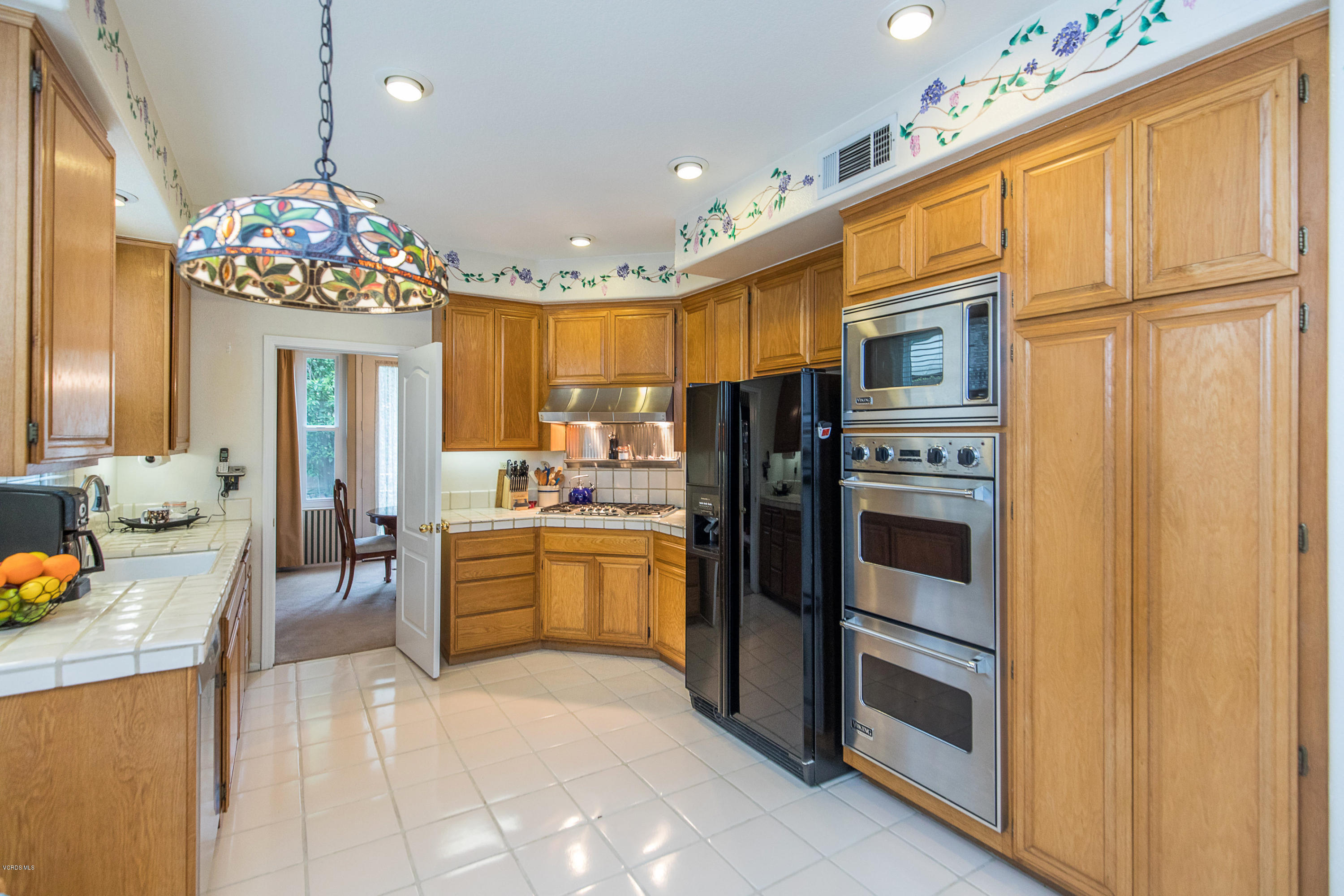 3959 Timberridge Road Moorpark, CA 93021 - Photo 17 of 48 a kitchen with stainless steel appliances kitchen island granite countertop a refrigerator and microwave