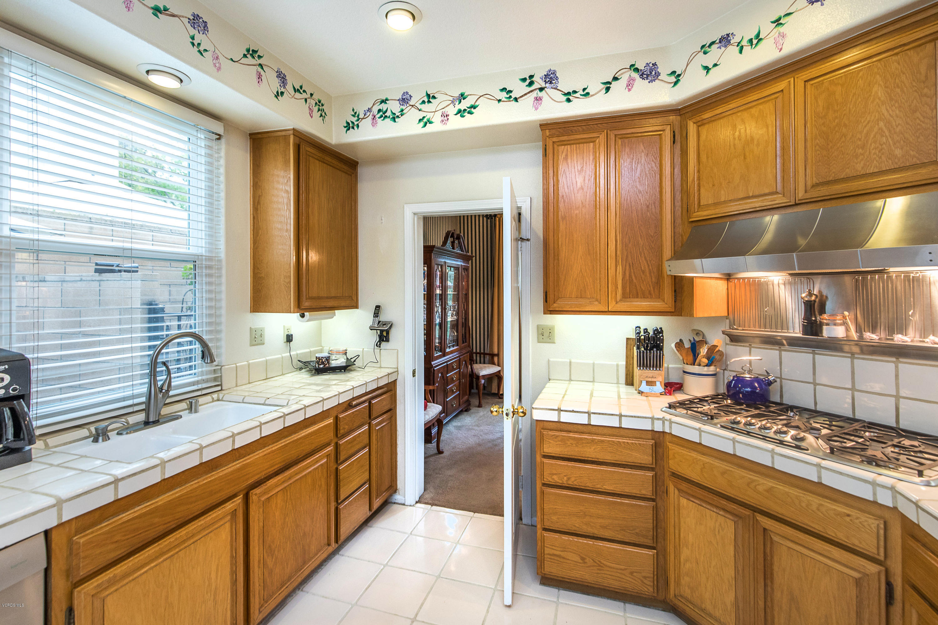 3959 Timberridge Road Moorpark, CA 93021 - Photo 18 of 48 a kitchen with kitchen island granite countertop a sink and cabinets