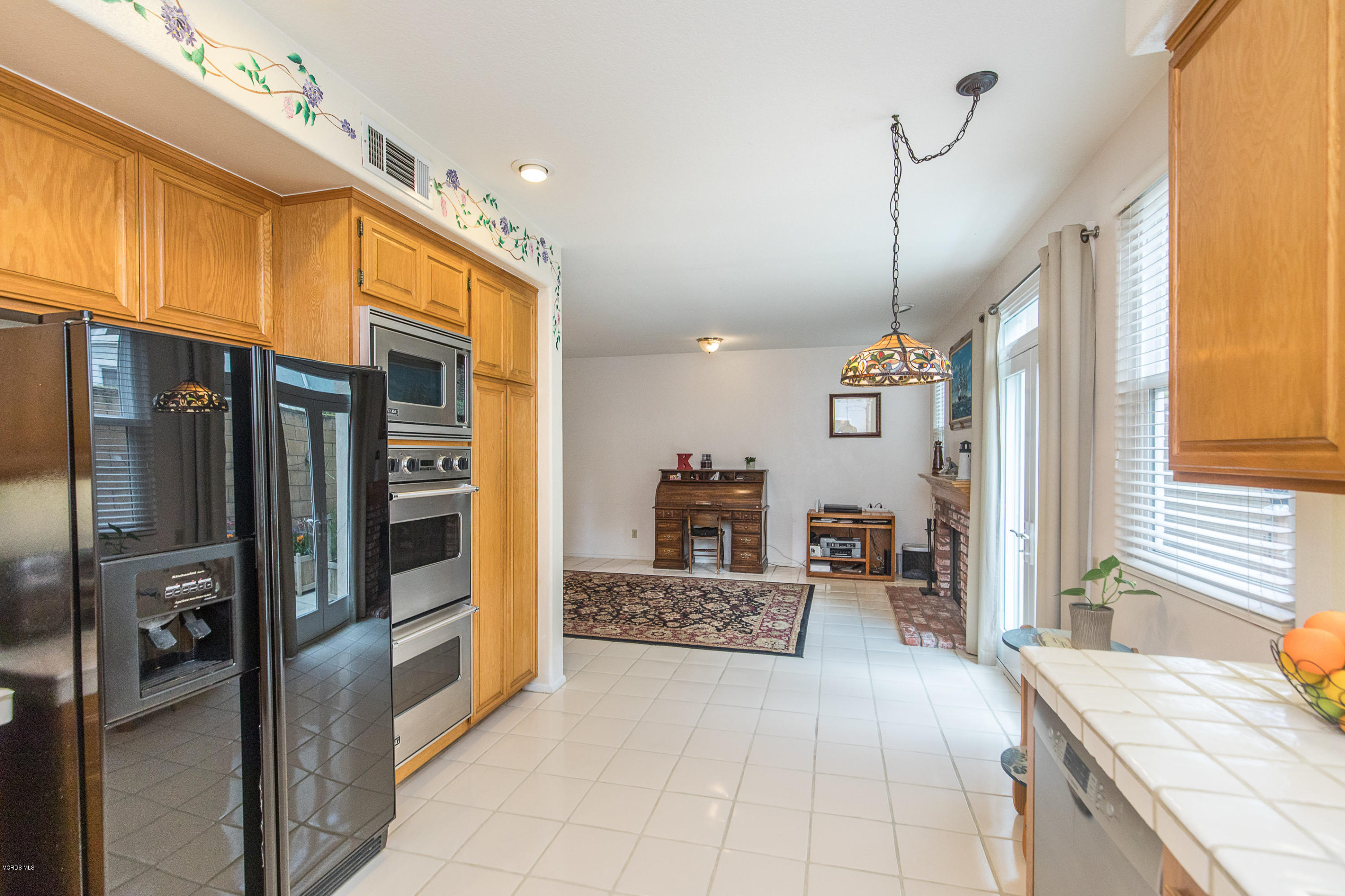 3959 Timberridge Road Moorpark, CA 93021 - Photo 19 of 48 a large kitchen with stainless steel appliances kitchen island granite countertop a refrigerator and a sink
