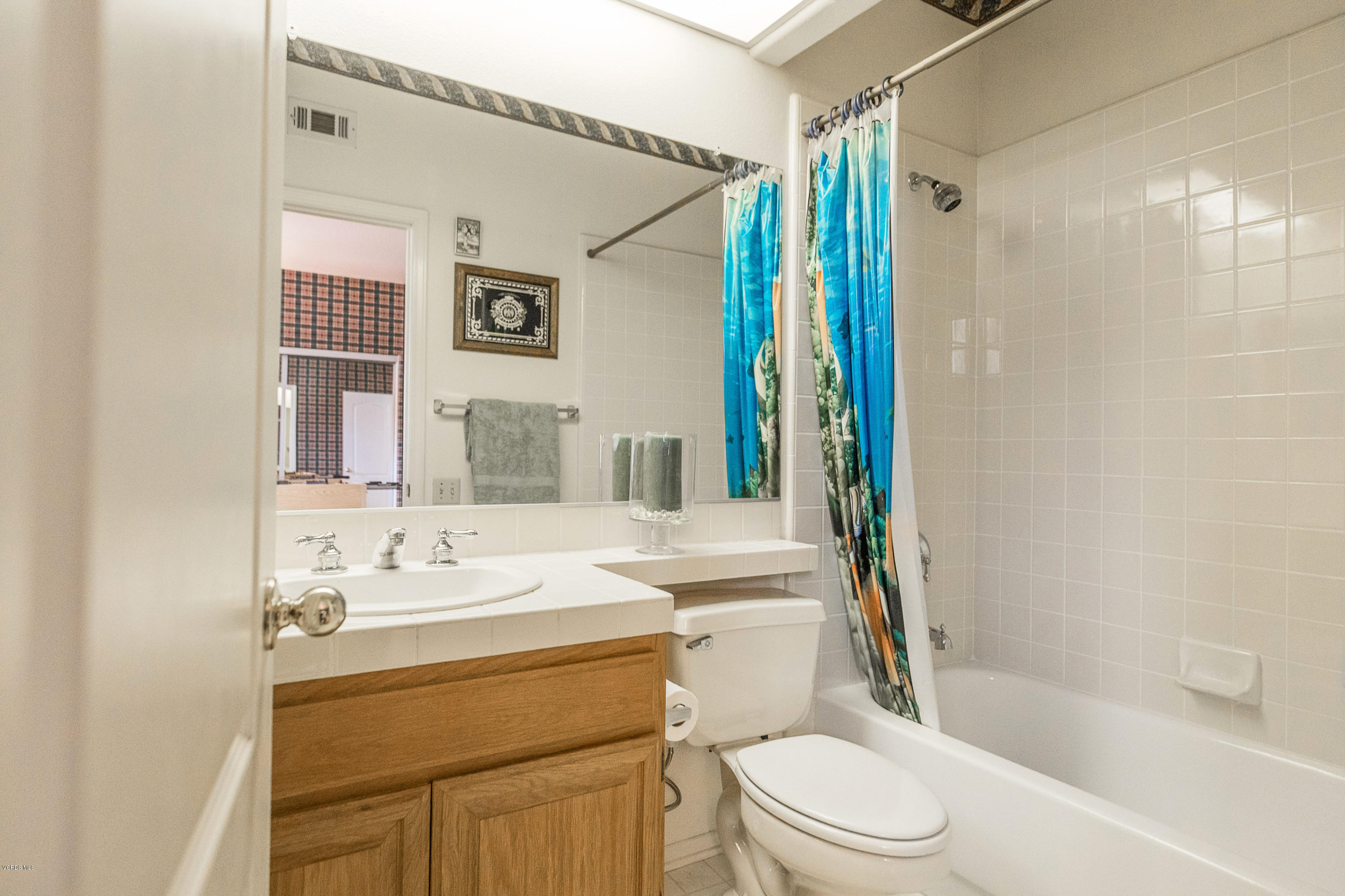 3959 Timberridge Road Moorpark, CA 93021 - Photo 29 of 48 a bathroom with a sink a toilet a mirror a vanity and shower