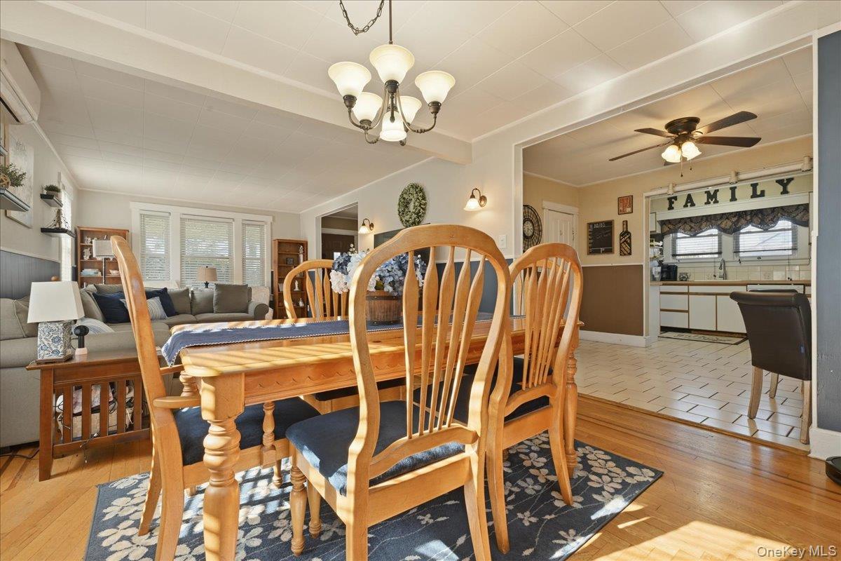 1165 Meadowbrook Road Merrick, NY 11566 - Photo 12 of 36 a view of a dining room with furniture and chandelier