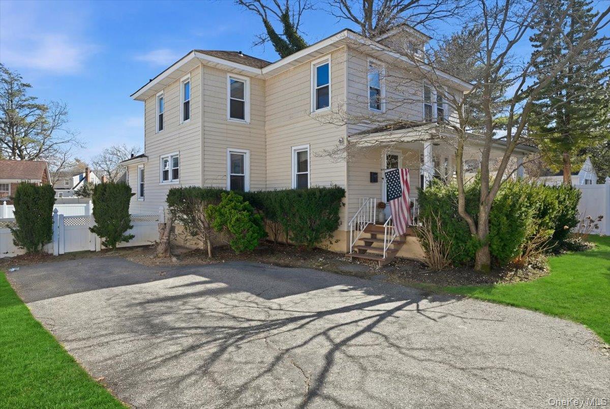 1165 Meadowbrook Road Merrick, NY 11566 - Photo 2 of 36 a view of a white house with a yard and plants
