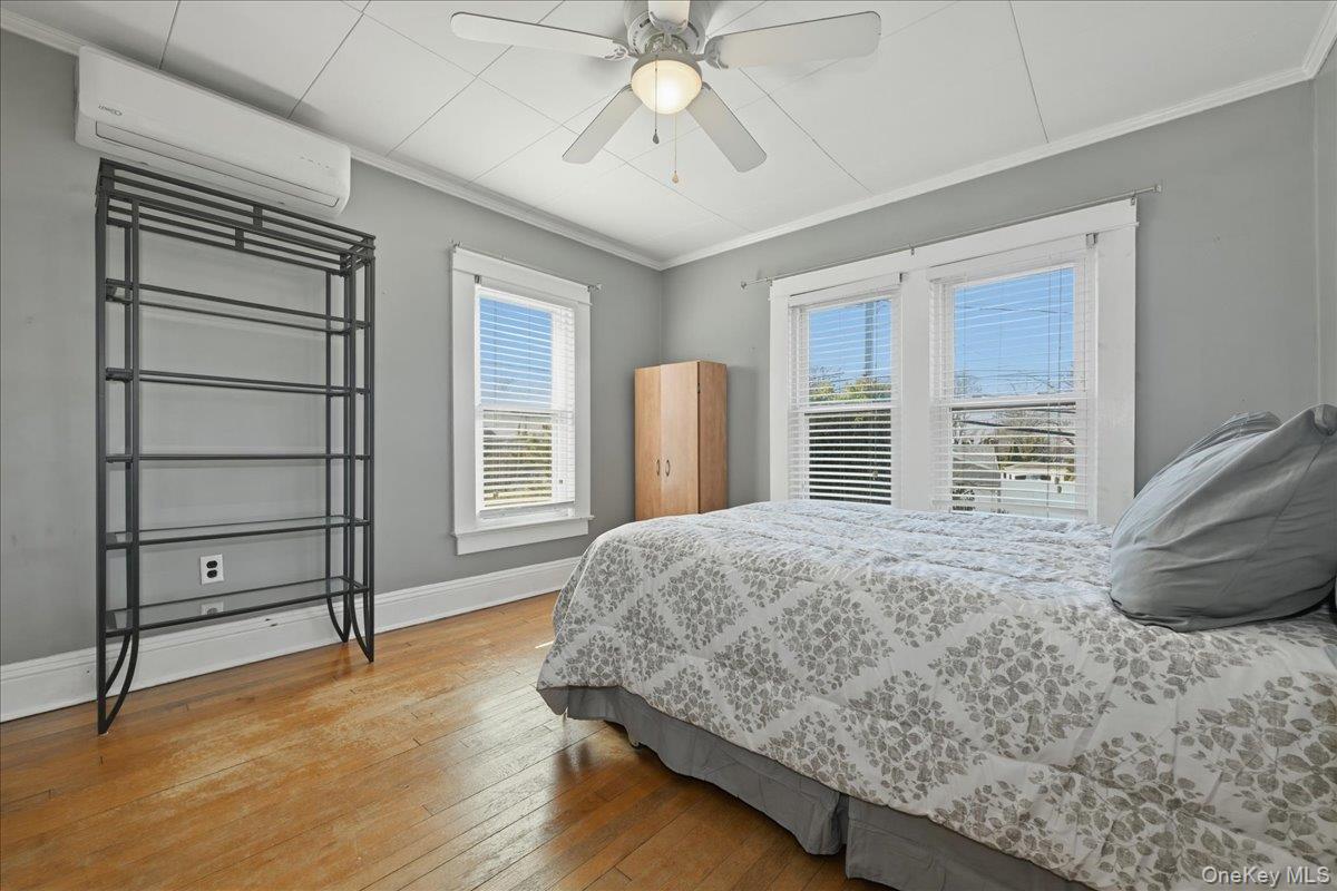 1165 Meadowbrook Road Merrick, NY 11566 - Photo 22 of 36 a bedroom with a bed and a large window