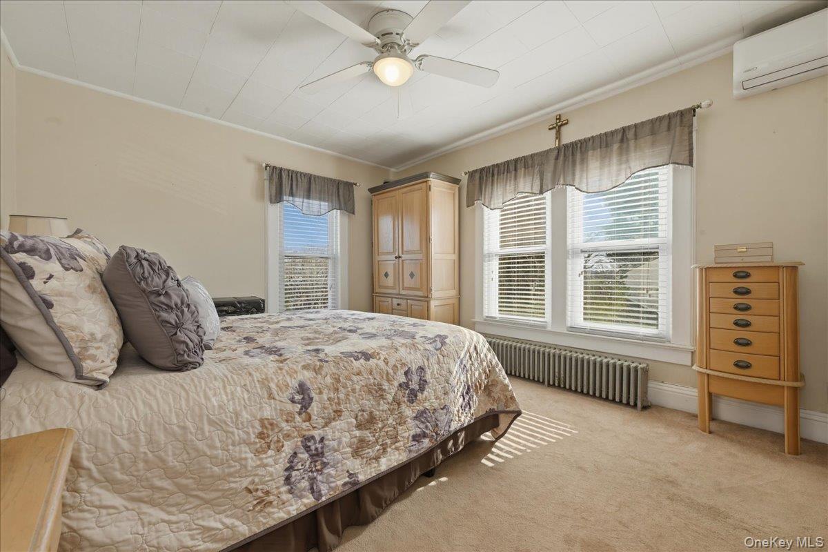 1165 Meadowbrook Road Merrick, NY 11566 - Photo 23 of 36 a bedroom with a bed and a large window