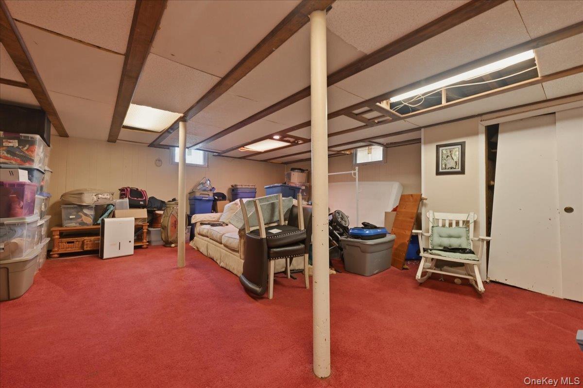 1165 Meadowbrook Road Merrick, NY 11566 - Photo 26 of 36 a living room with furniture and a flat screen tv