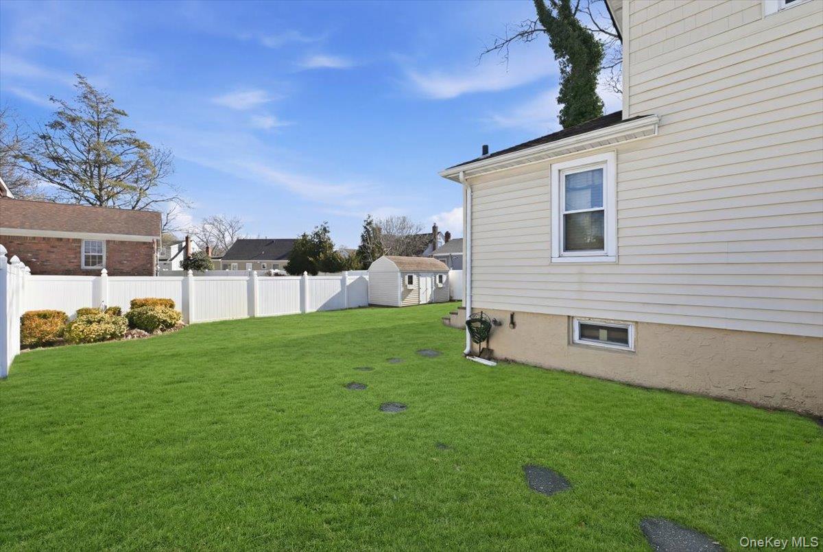1165 Meadowbrook Road Merrick, NY 11566 - Photo 29 of 36 a view of a backyard with plants and a garden