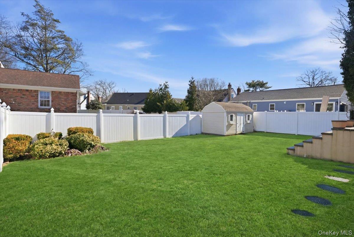 1165 Meadowbrook Road Merrick, NY 11566 - Photo 30 of 36 a view of an house with backyard space and garden