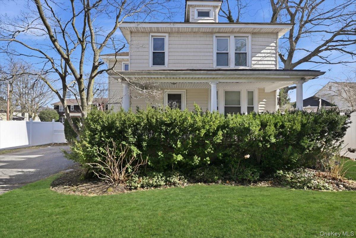 1165 Meadowbrook Road Merrick, NY 11566 - Photo 3 of 36 a front view of a house with a garden