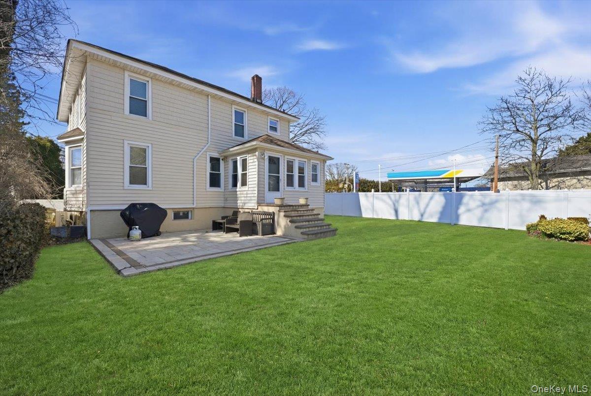 1165 Meadowbrook Road Merrick, NY 11566 - Photo 32 of 36 a front view of house with backyard and garden