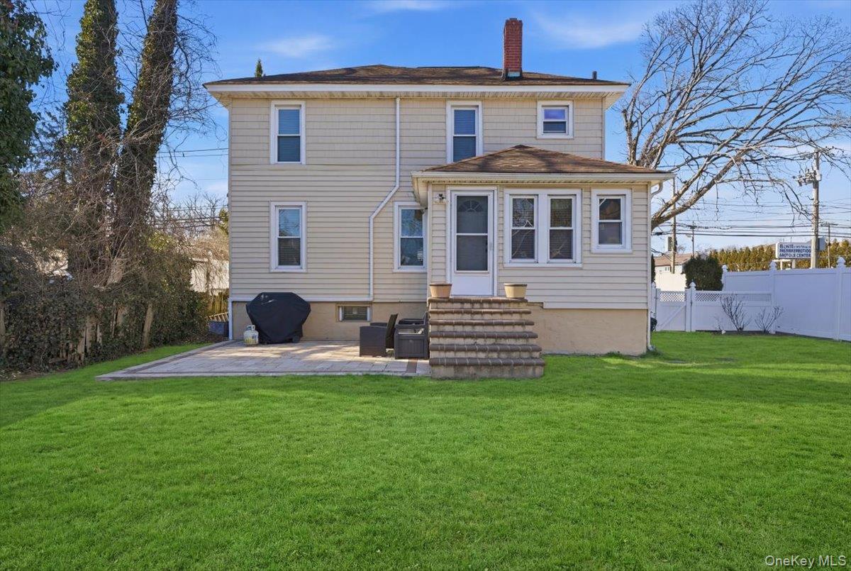 1165 Meadowbrook Road Merrick, NY 11566 - Photo 34 of 36 a front view of a house with a garden and yard