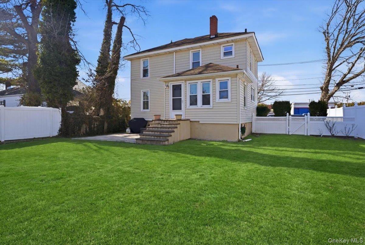 1165 Meadowbrook Road Merrick, NY 11566 - Photo 35 of 36 a front view of house with yard and outdoor seating