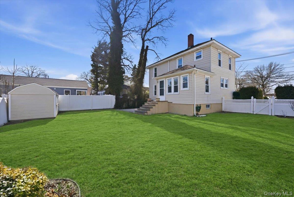 1165 Meadowbrook Road Merrick, NY 11566 - Photo 36 of 36 a front view of a house with garden