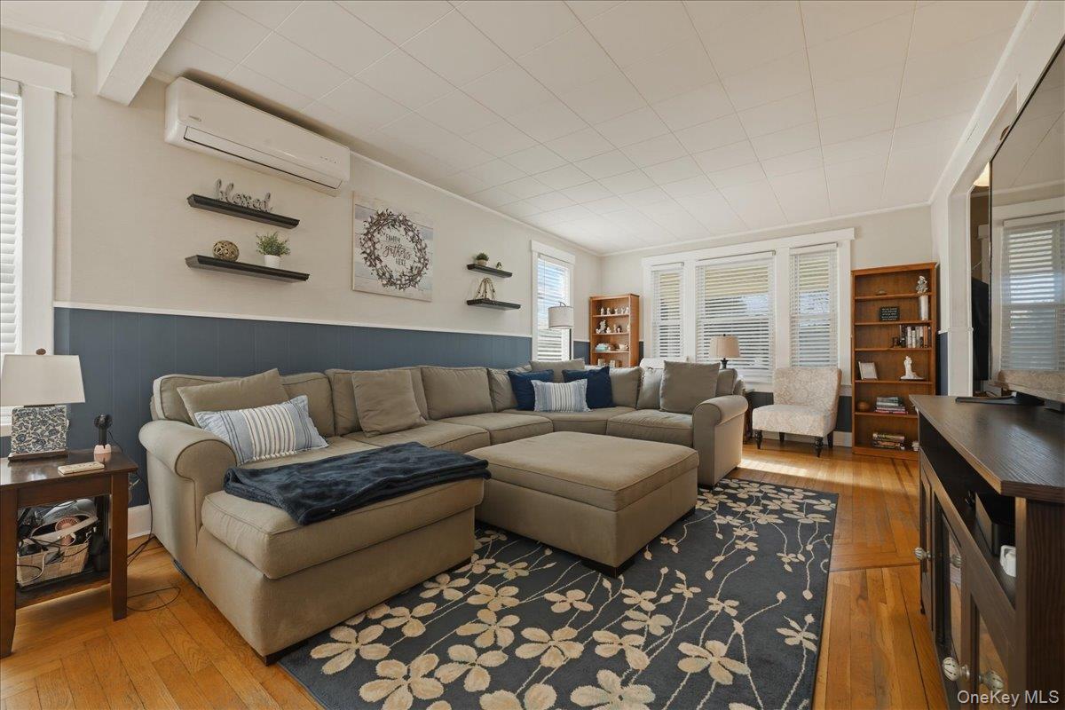 1165 Meadowbrook Road Merrick, NY 11566 - Photo 8 of 36 a living room with furniture and a flat screen tv