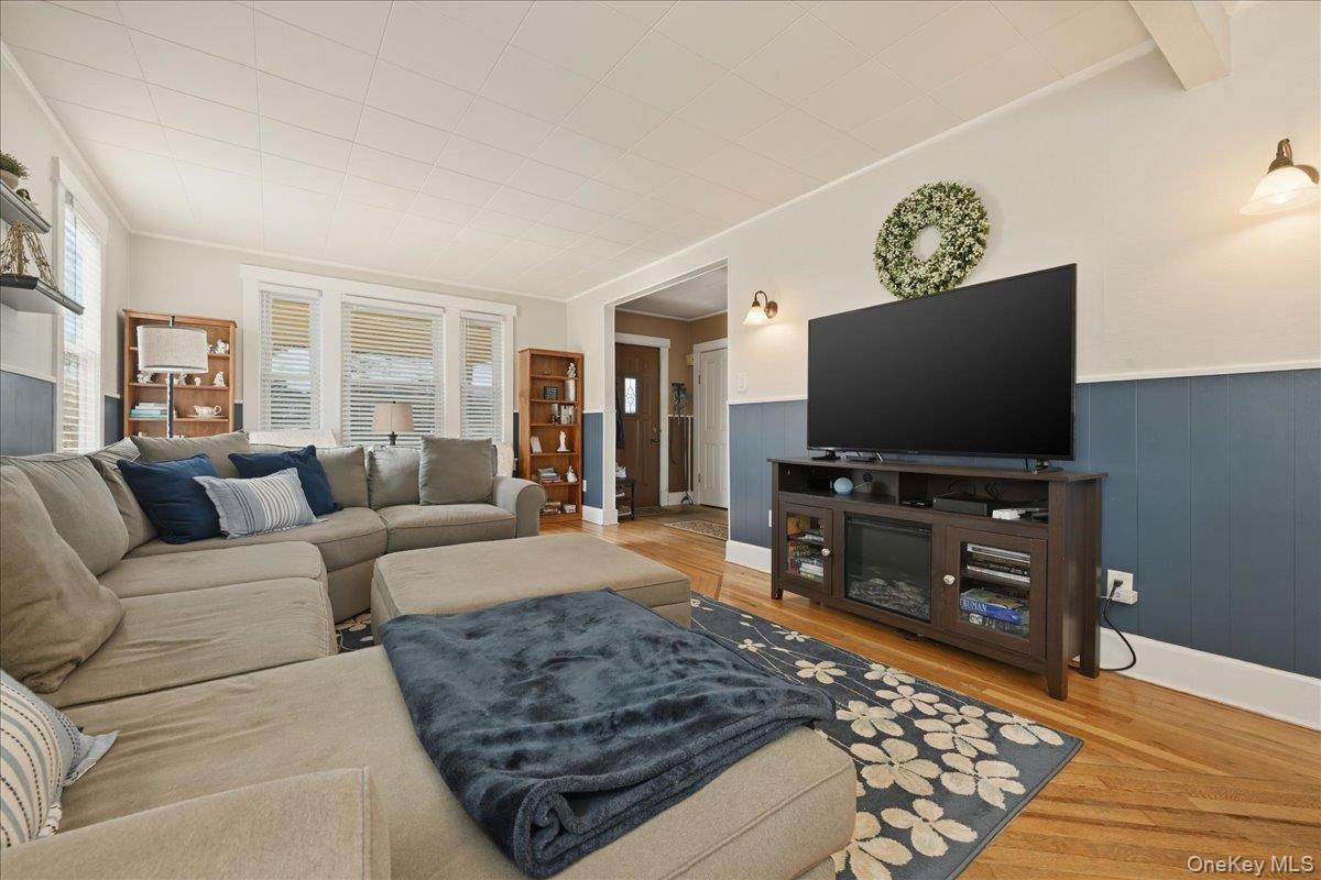 1165 Meadowbrook Road Merrick, NY 11566 - Photo 9 of 36 a living room with furniture and a flat screen tv