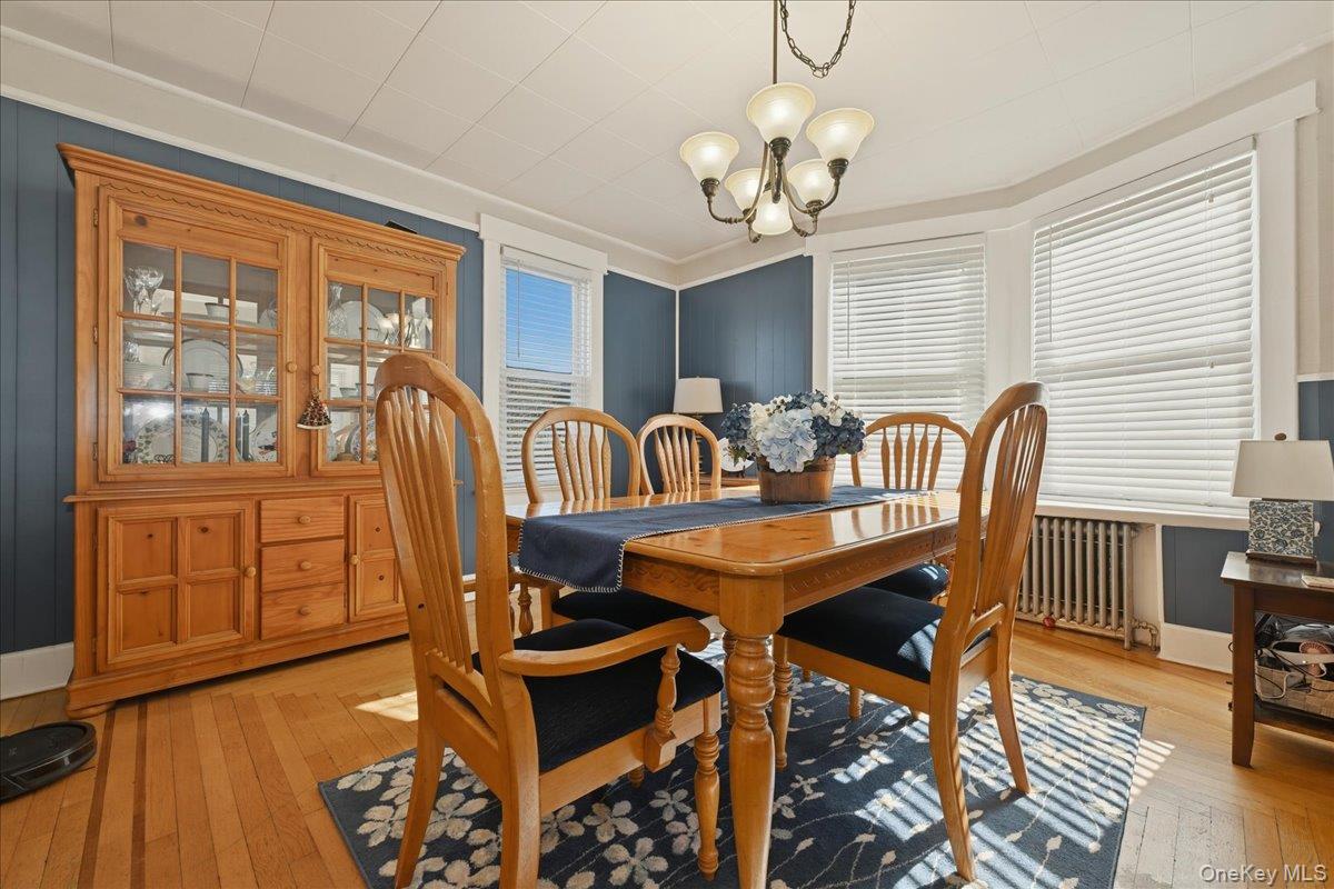 1165 Meadowbrook Road Merrick, NY 11566 - Photo 10 of 36 a view of a dining room with furniture wooden floor and chandelier