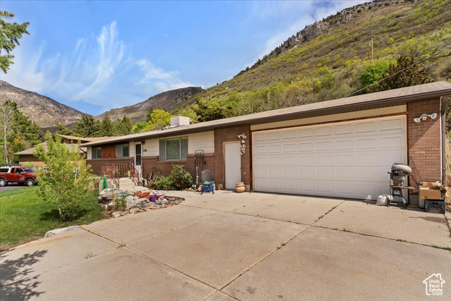 2268 North Mountain Road North Ogden, UT 84414 - Photo 1 of 1 Ranch-style house featuring brick siding, concrete driveway, and a mountain view