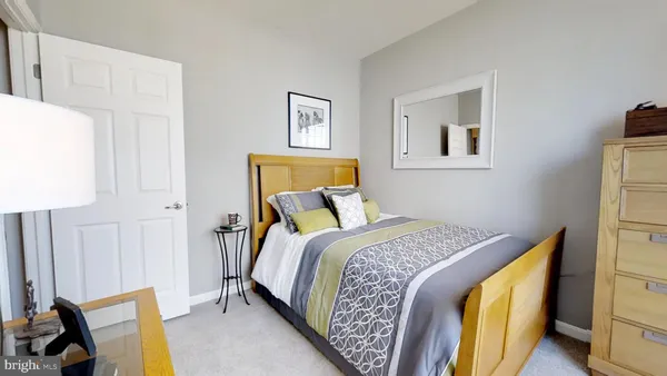 a bed room with a bed and a chair