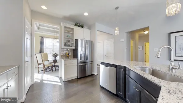 a kitchen with a refrigerator and a sink