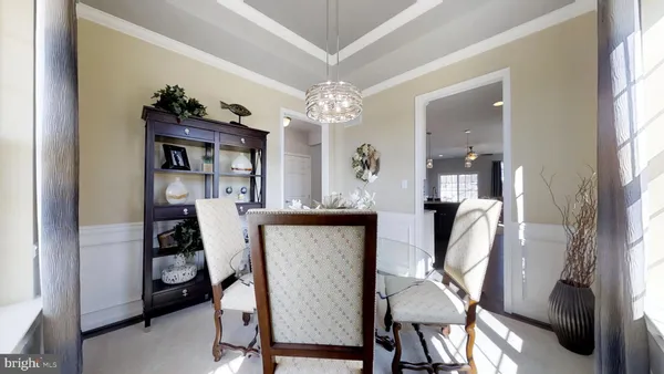 a view of a dining room with furniture and a chandelier