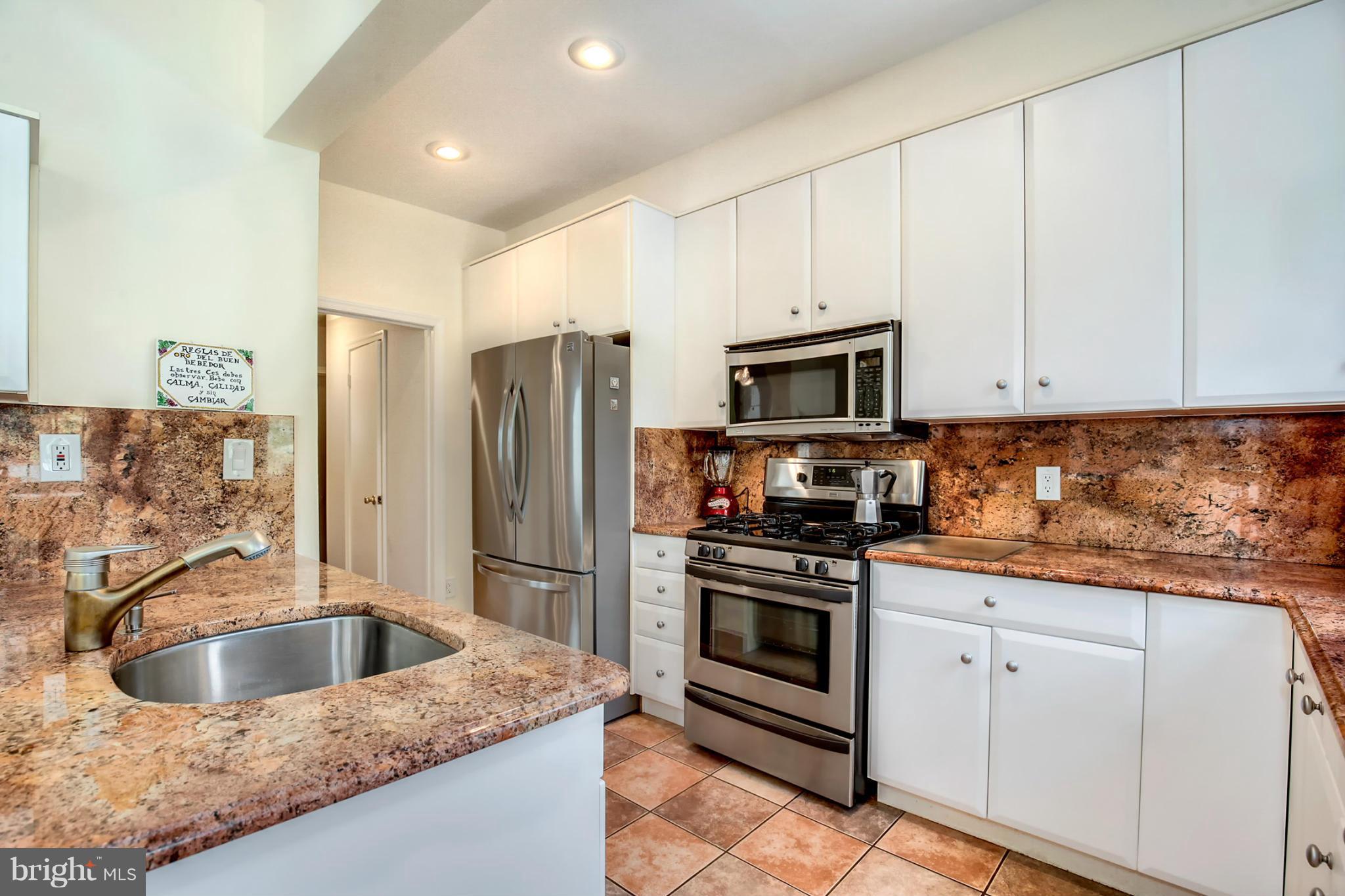 3835 Military Road Northwest Washington, DC 20015 - Photo 11 of 28 a kitchen with granite countertop a sink stove and refrigerator