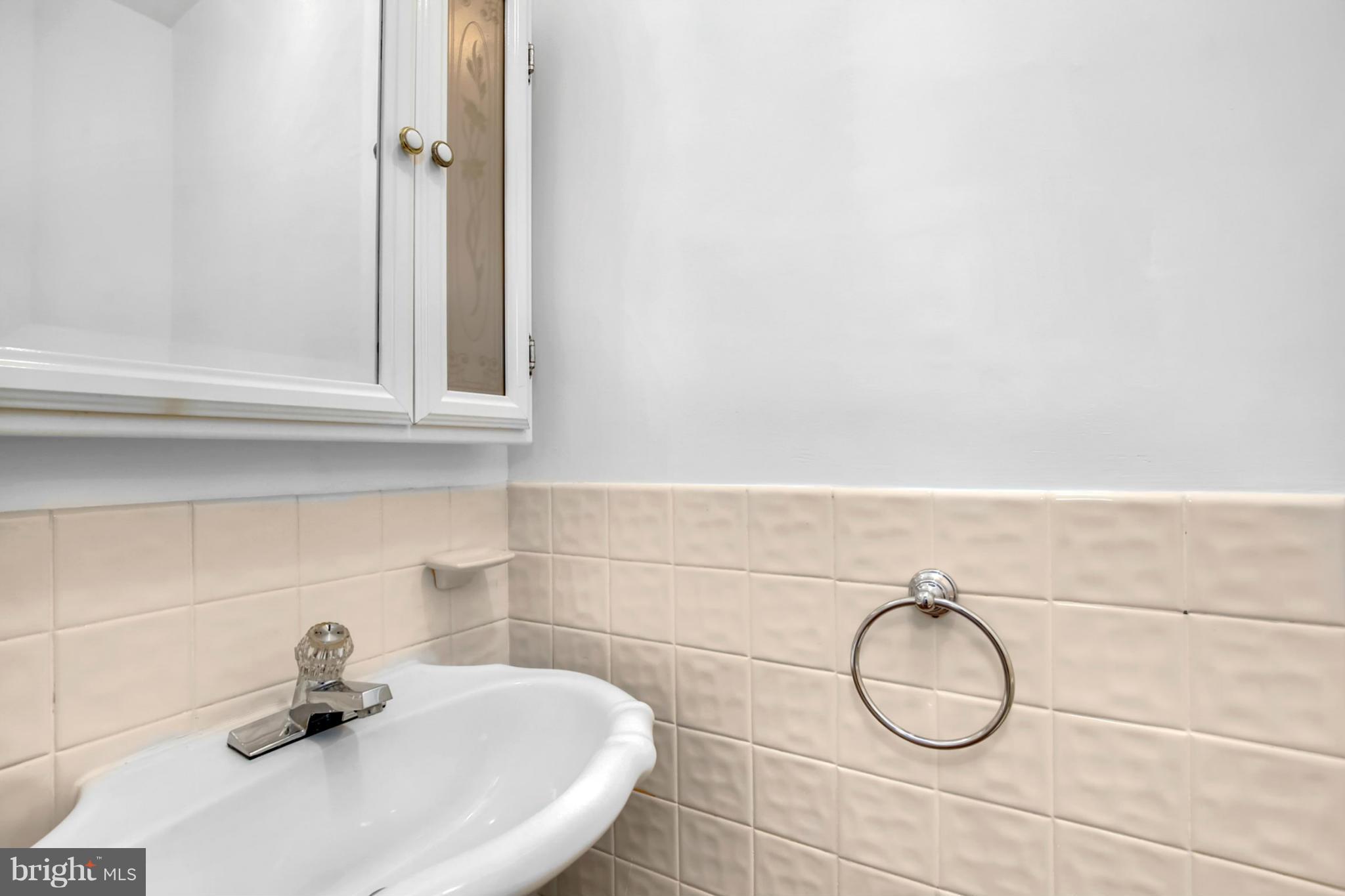 3835 Military Road Northwest Washington, DC 20015 - Photo 13 of 28 a bathroom with a sink and a window