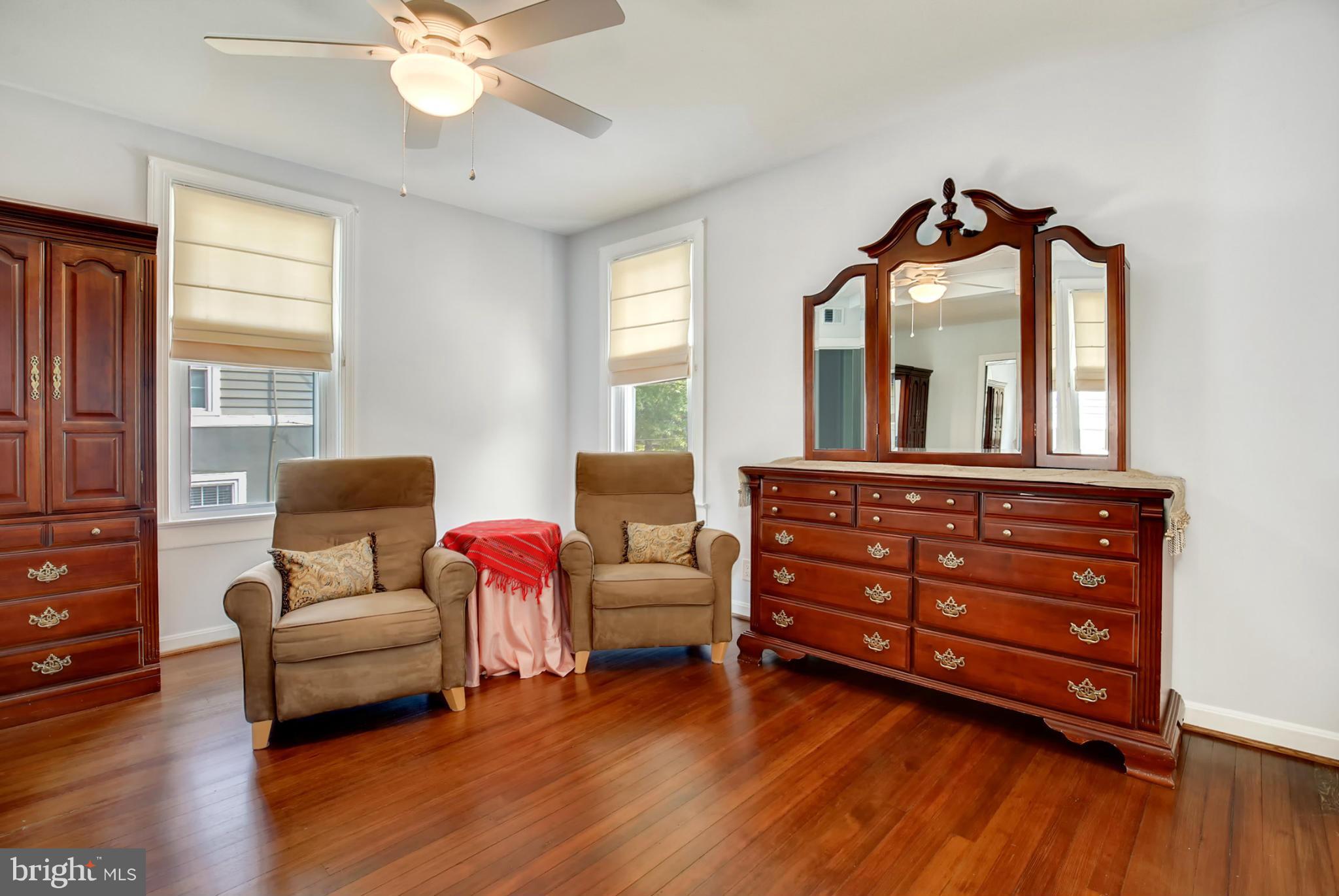 3835 Military Road Northwest Washington, DC 20015 - Photo 15 of 28 a living room with furniture and a large mirror next to a window
